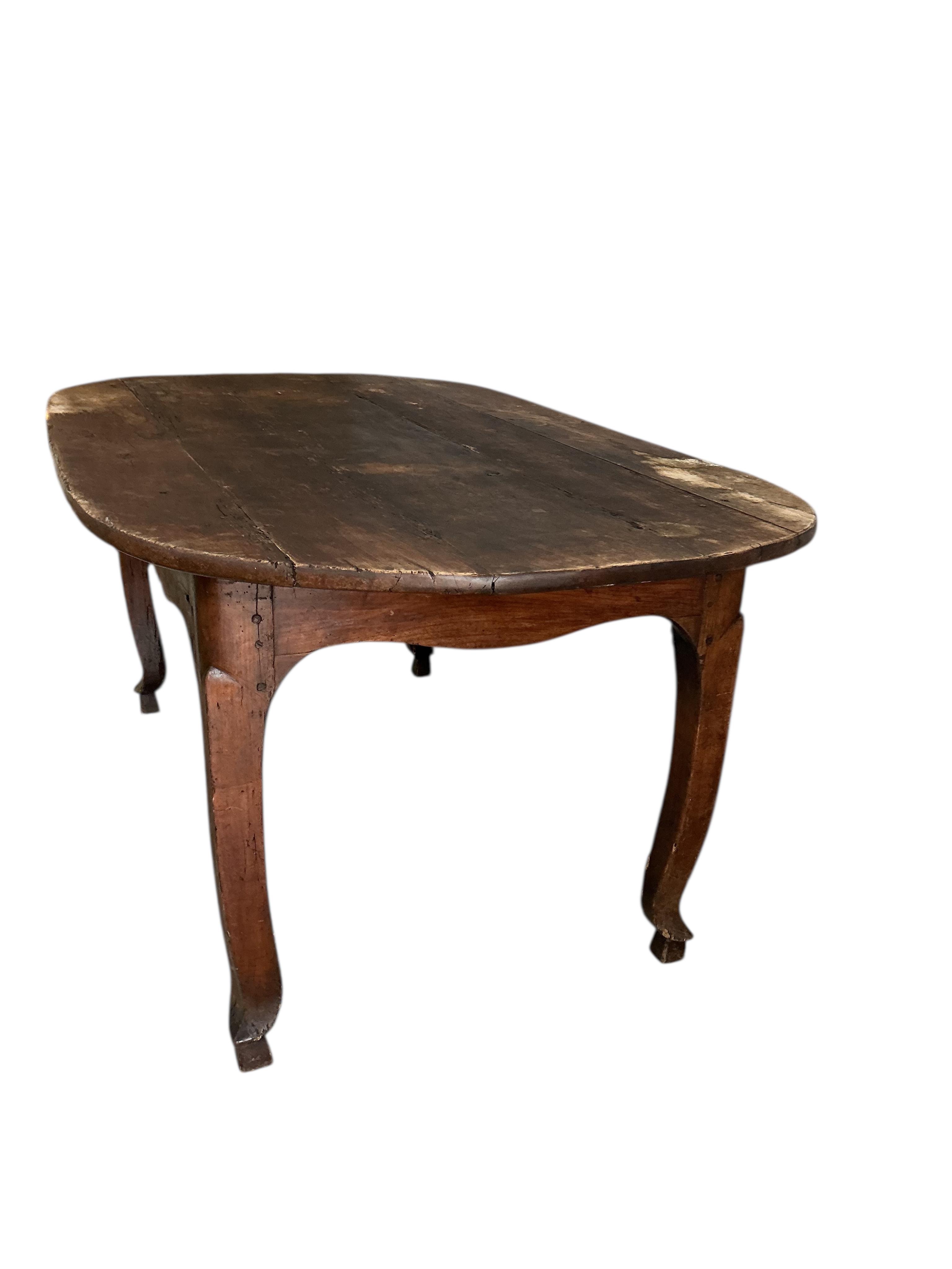 An early 19th century French Provincial oval fruitwood kitchen table, width 180cm, depth 104cm, height 77cm